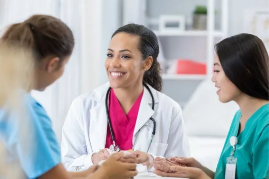 Orange_Medical_Care_Home_Doctors_And_Nurse_Talking